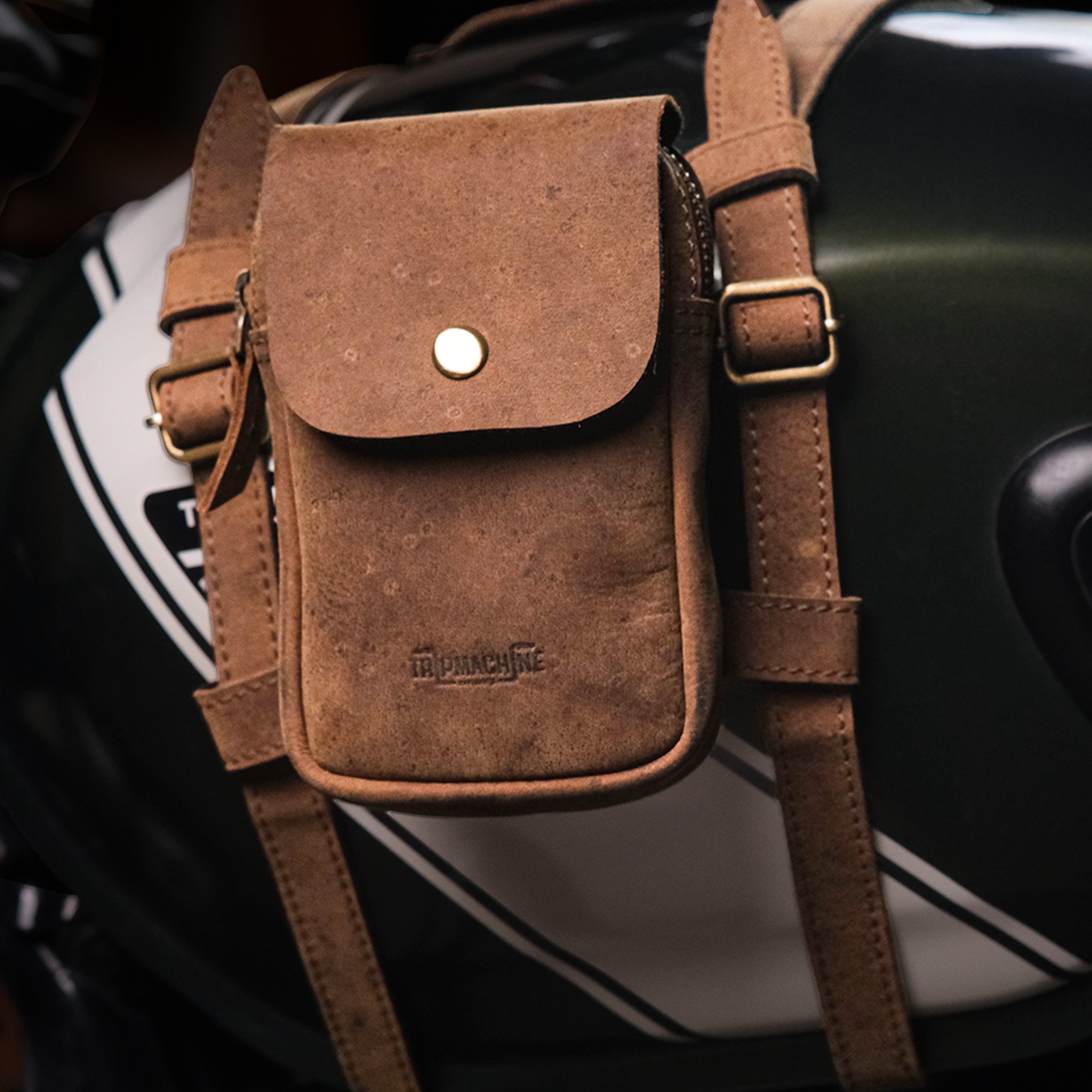 Brown leather utility pouch with tank strap on a motorcycle
