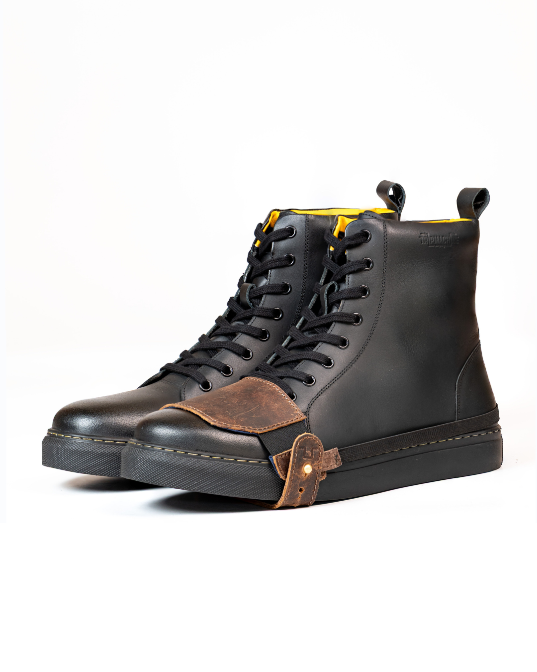 Black sneaker boots with mocha shoe protector on a white background