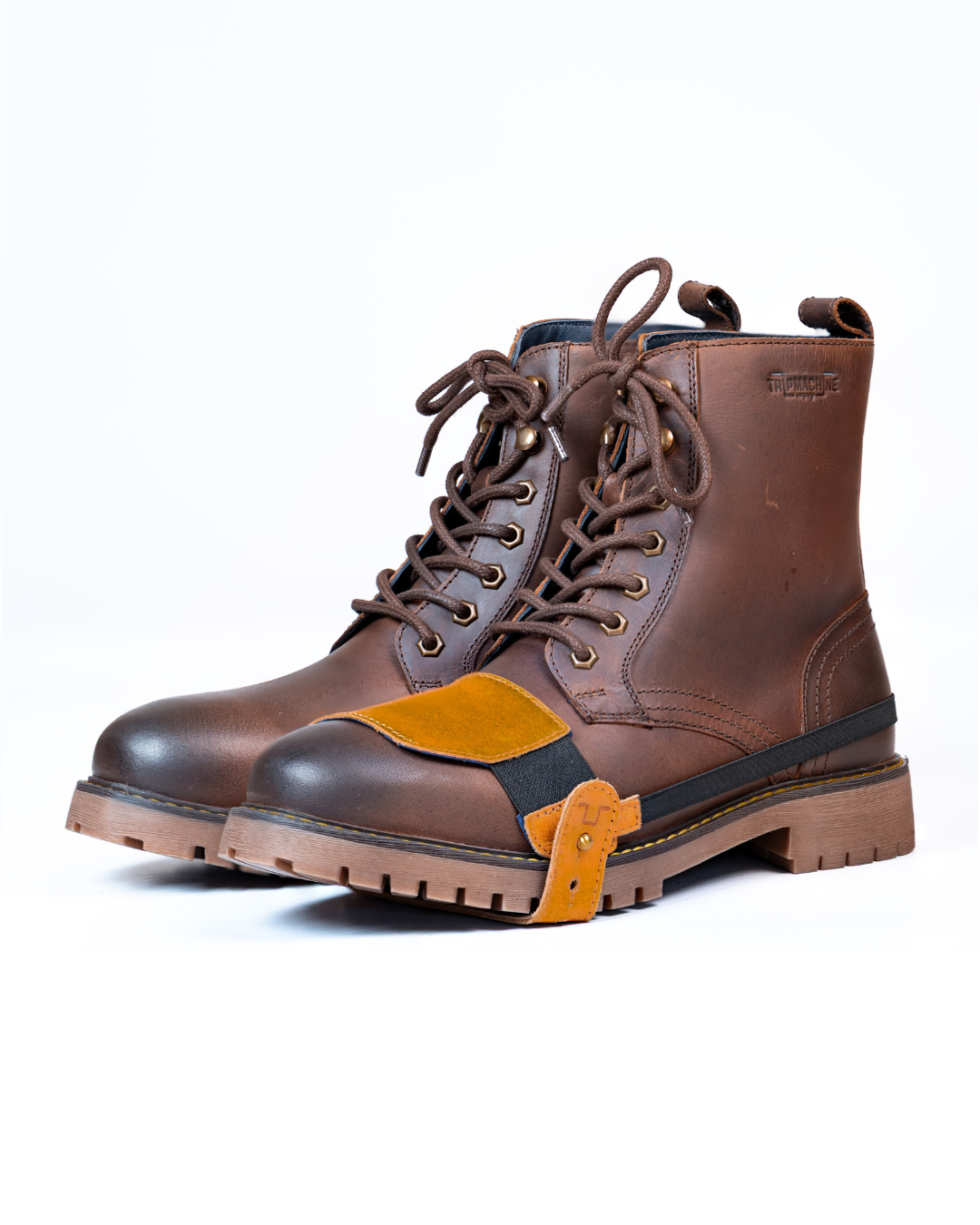 Brown leather boot with tan shoe protector on a white background