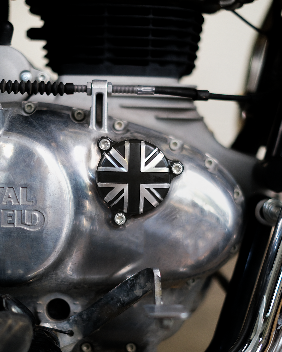 Close-up of a motorcycle engine with a Union Jack emblem and 'Royal Enfield' branding.