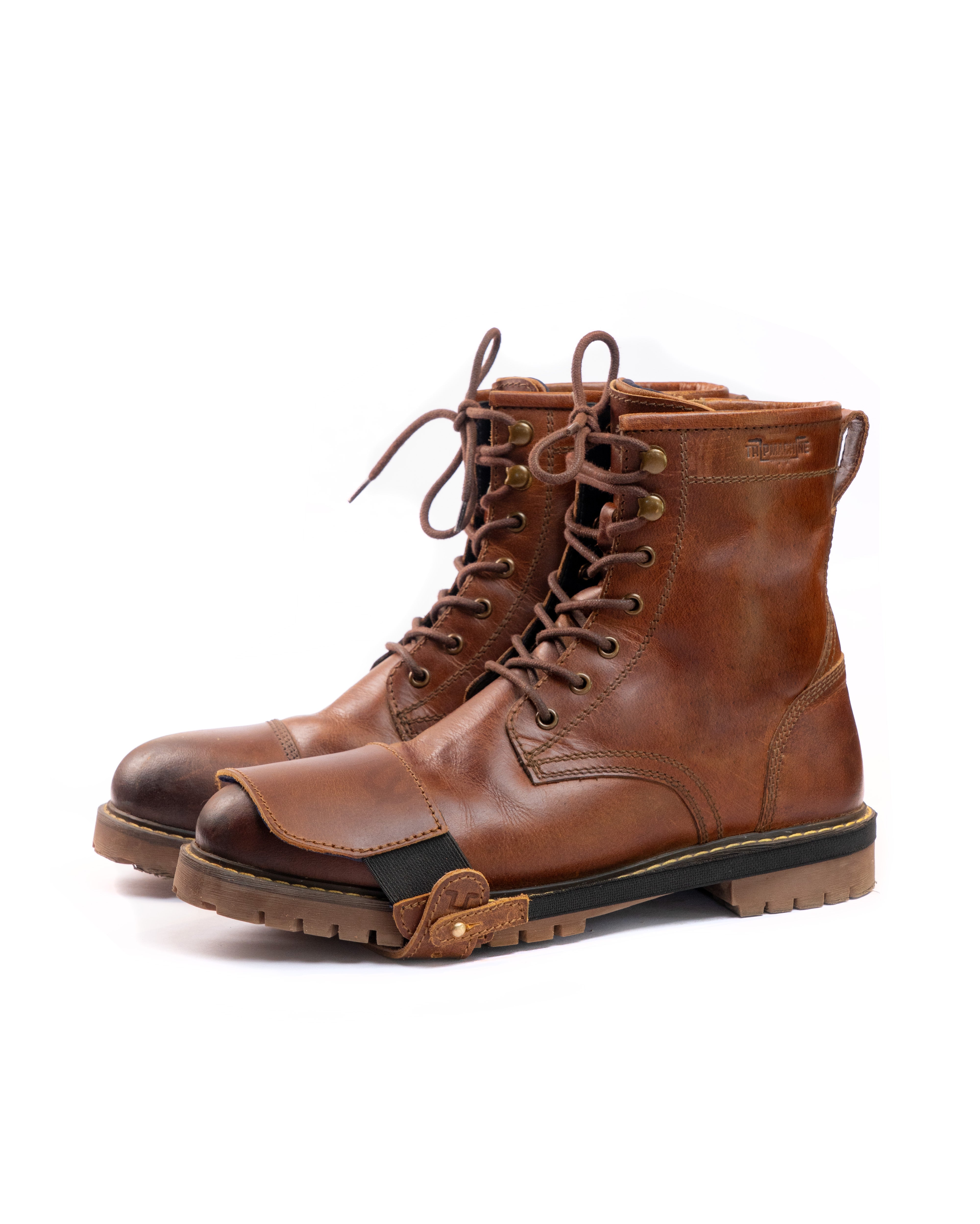 Pair of cognac leather boots on a white background