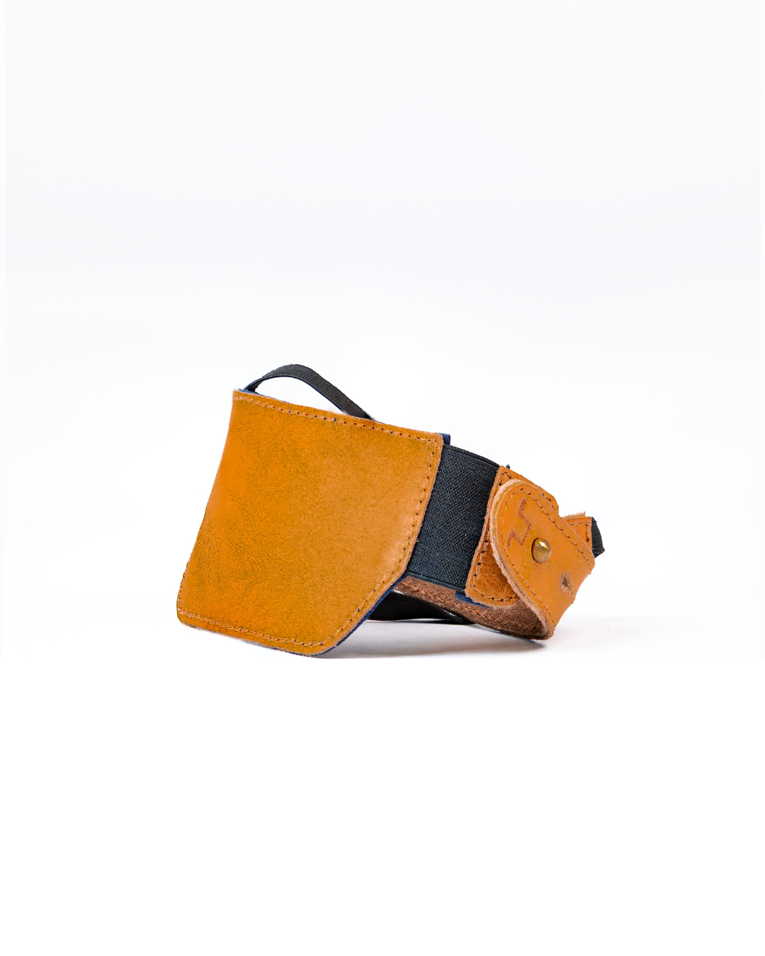 Vintage tan leather shoe protector on a white background