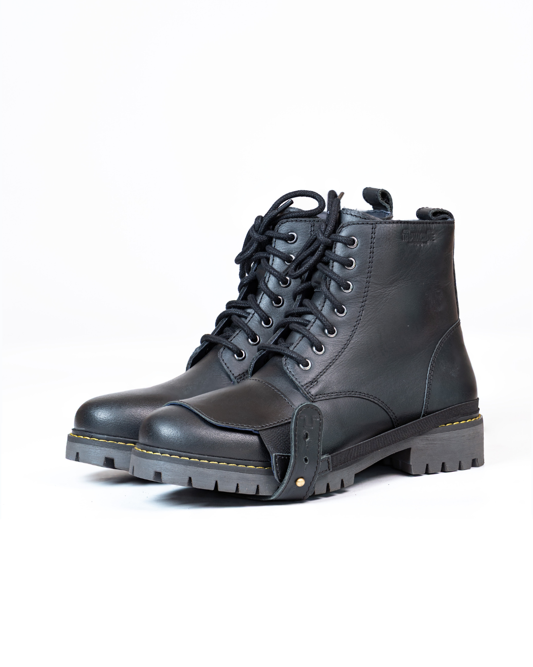 Black leather boots with black shoe protector on a white background