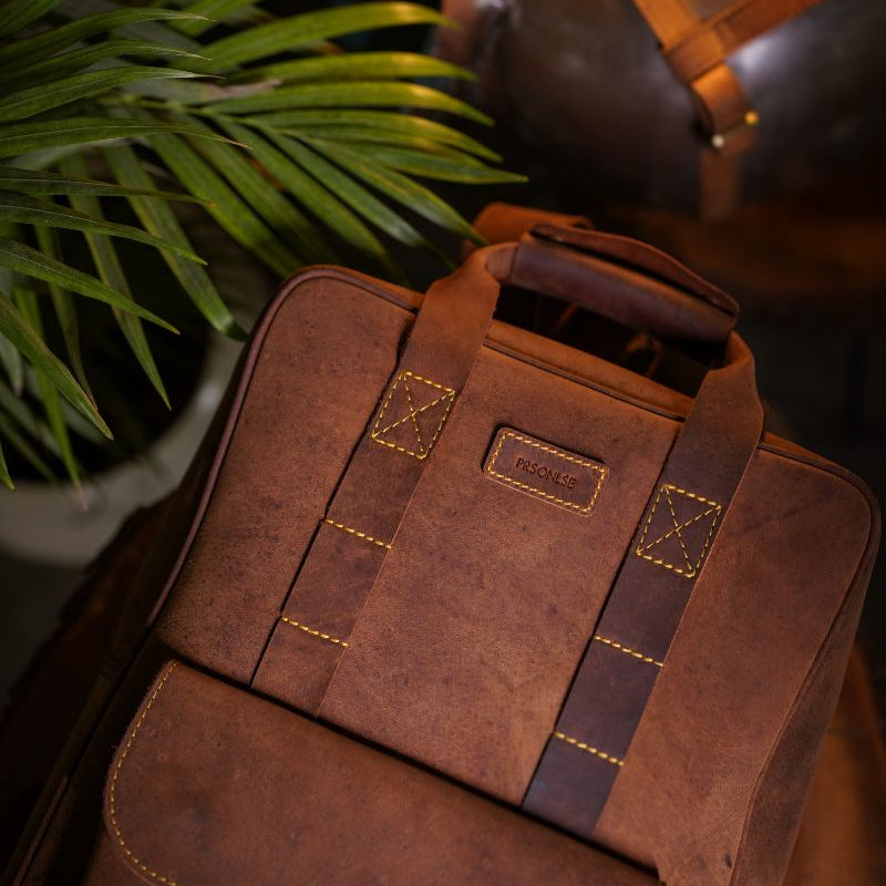 Front view of handmade genuine leather brown color eastwood backpack on wooden log