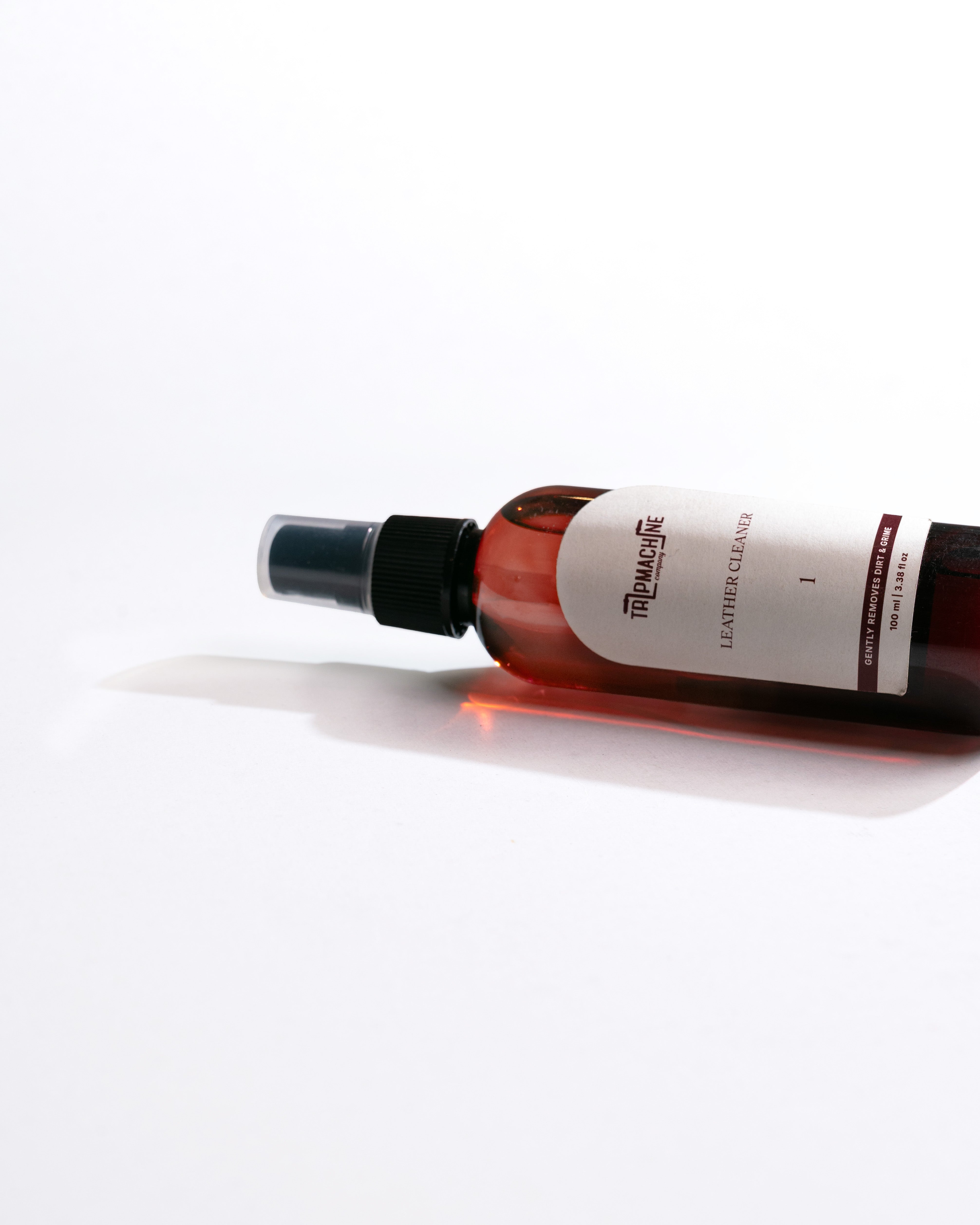 Bottle of leather cleaner with a white label on a white background
