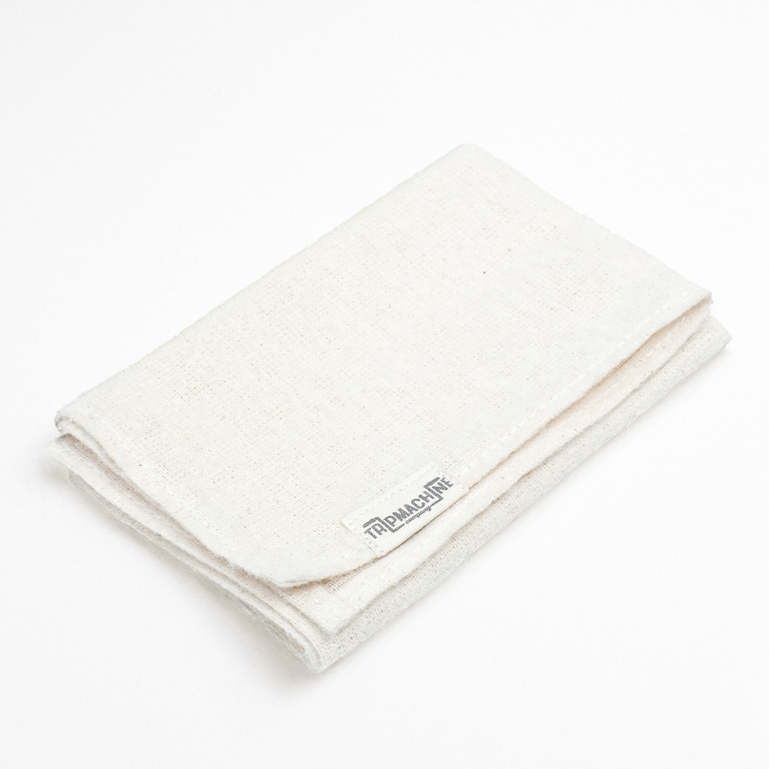 Folded white cloth with a brand logo on a white background
