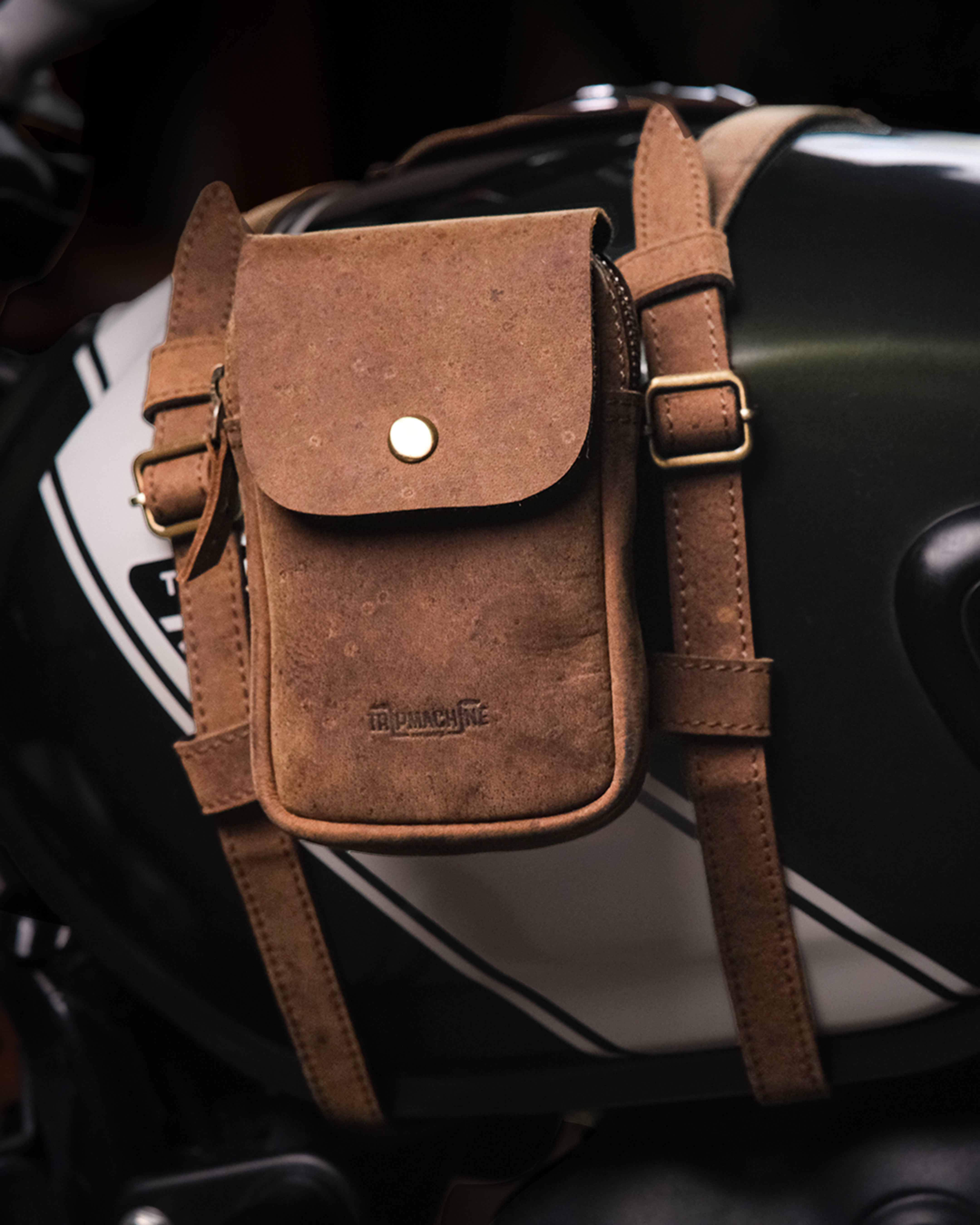 Brown leather utility pouch with tank strap on a motorcycle