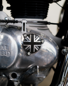Close-up of a motorcycle engine with a Union Jack emblem and 'Royal Enfield' branding.