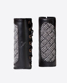 Pair of black leather grips with textured pattern on a white background