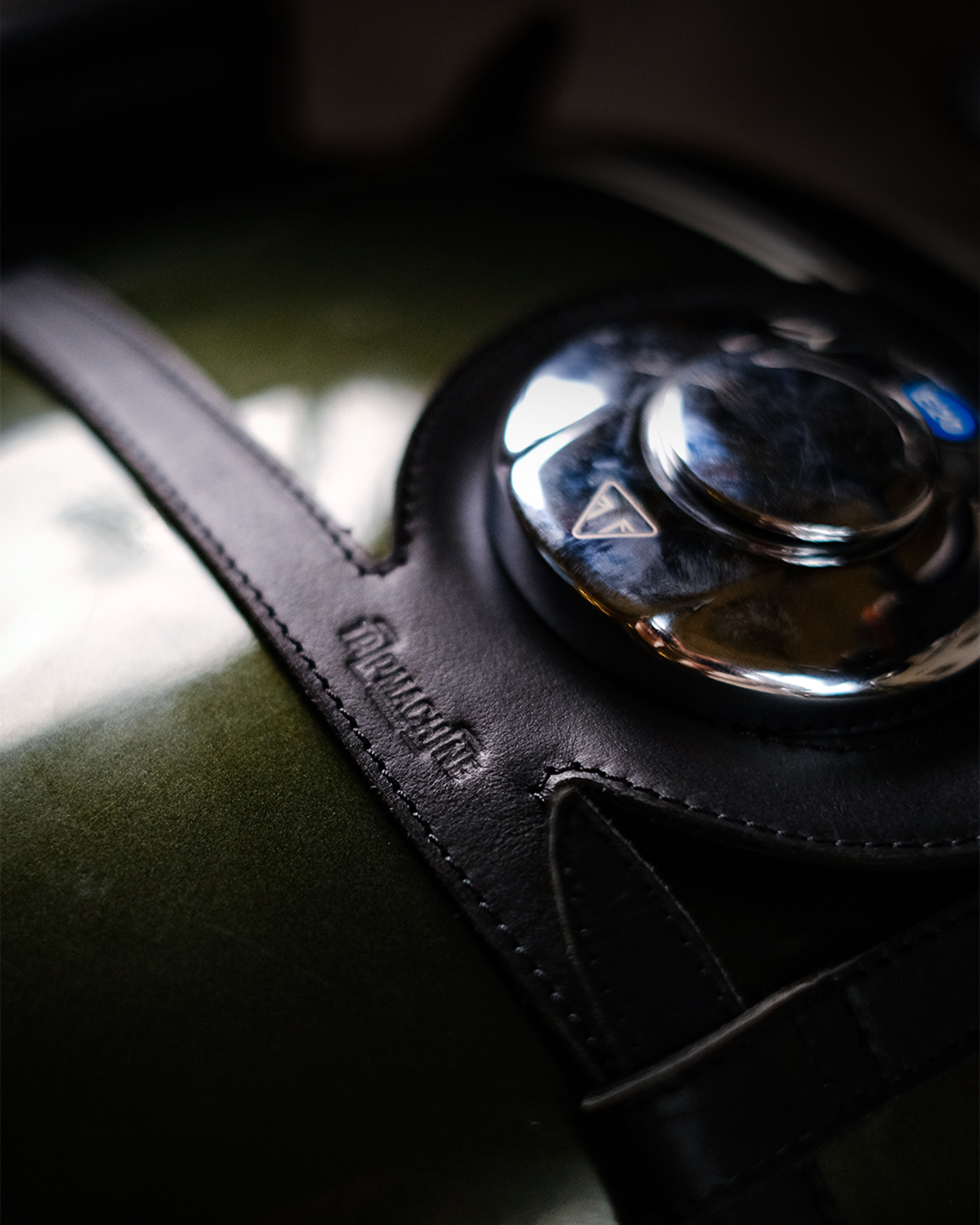 Close-up of a car's gear shift lever with a leather cover