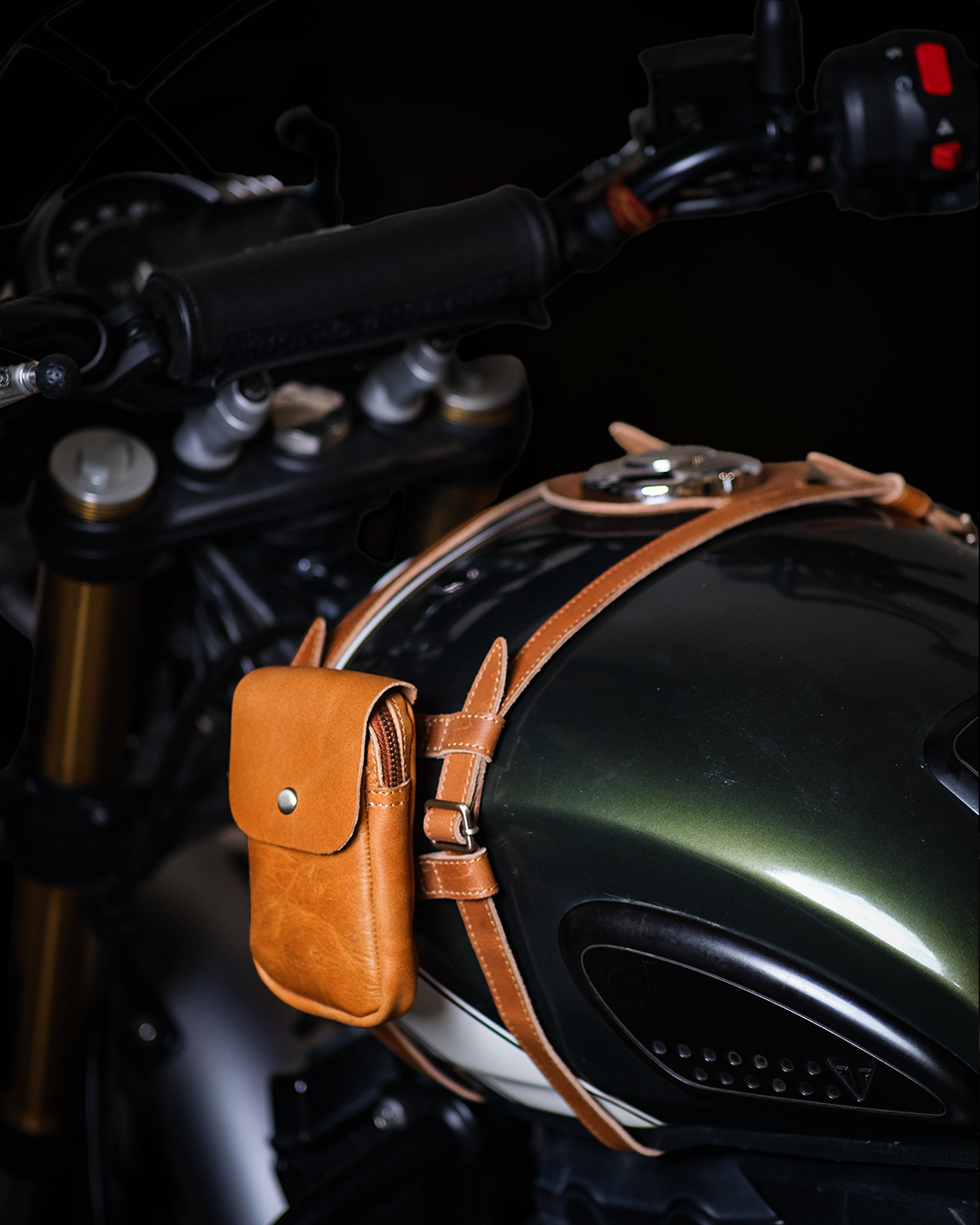 Brown leather pouch attached to a motorcycle