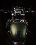 Close-up of a motorcycle's front section with a dark background