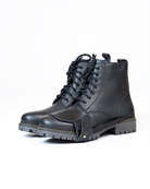 Black leather boots with black shoe protector on a white background