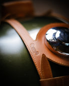 Close-up of a leather product with a brand name on a dark background
