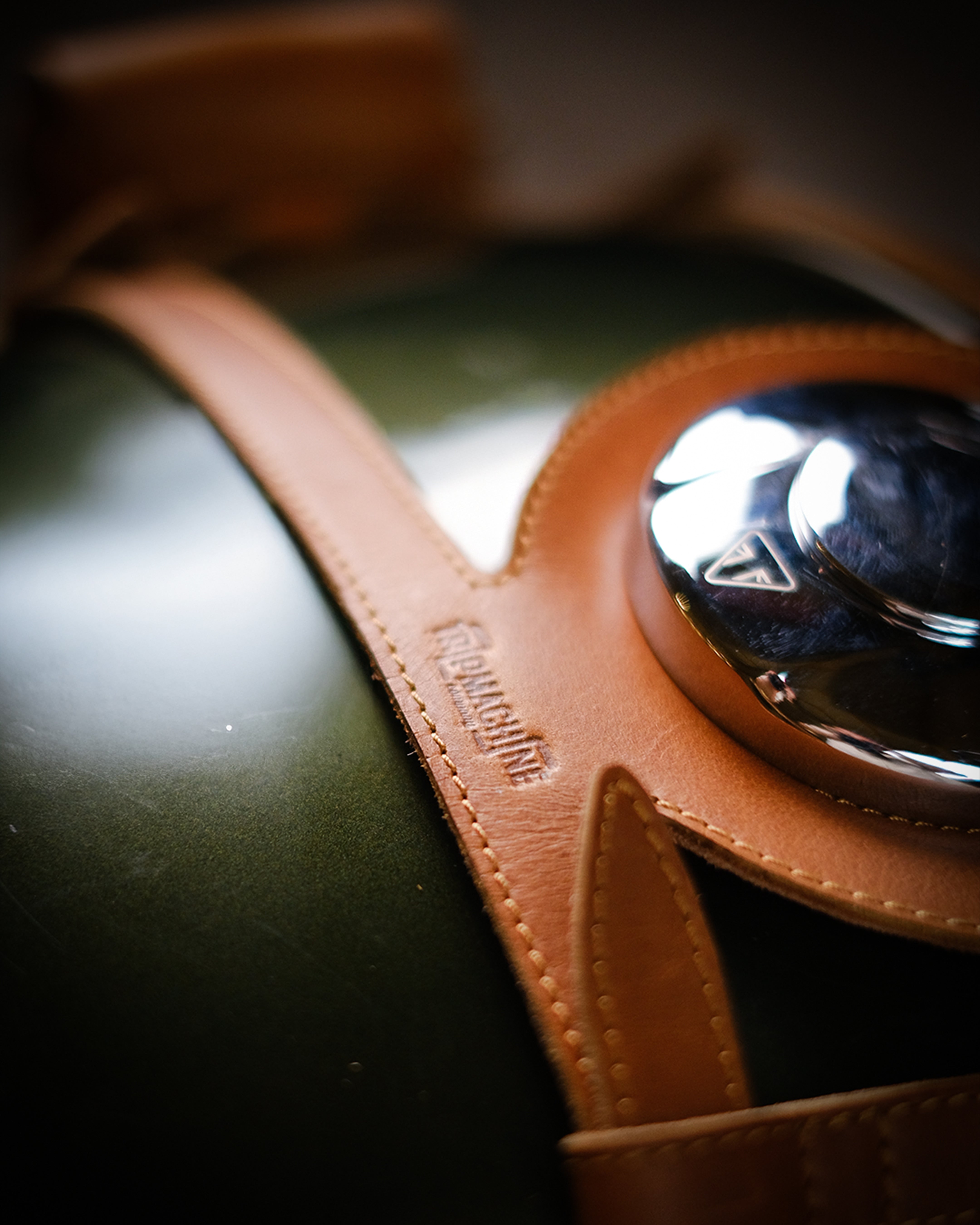 Close-up of a leather product with a brand name on a dark background