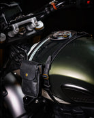 Black leather pouch attached to a motorcycle's fuel tank