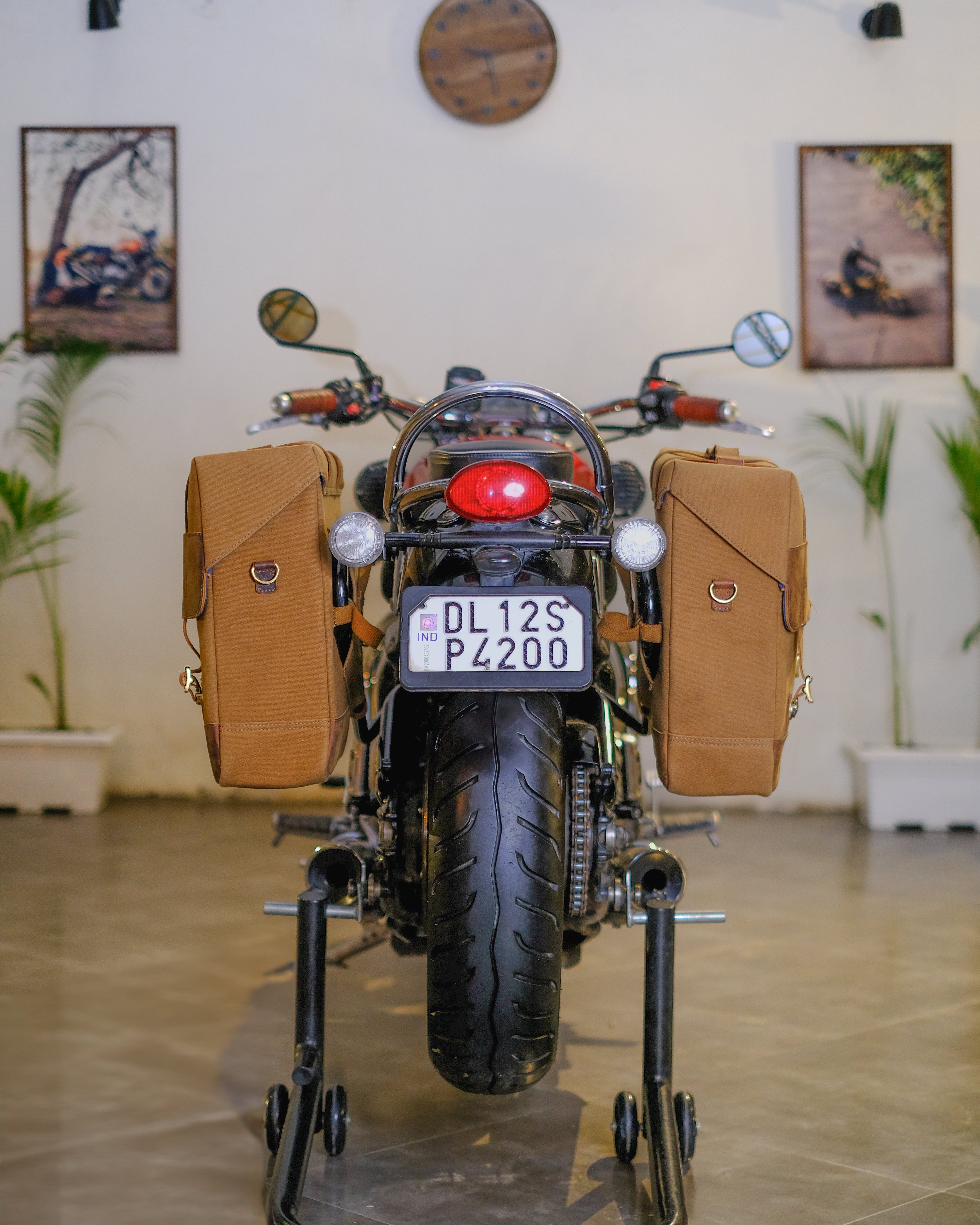 Motorcycle with brown saddlebags on a stand indoors