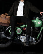 Full view of a man seated on a bike with black color handmade genuine leather derby boots with ankle, toe and heel protector for bikers