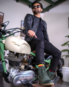 Man seated on harley davidson with handmade genuine leather derby forest green boots with ankle, toe and heel protector for bikers