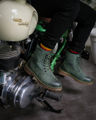 Man seated on a bike with handmade genuine leather derby forest green boots with ankle, toe and heel protector for bikers