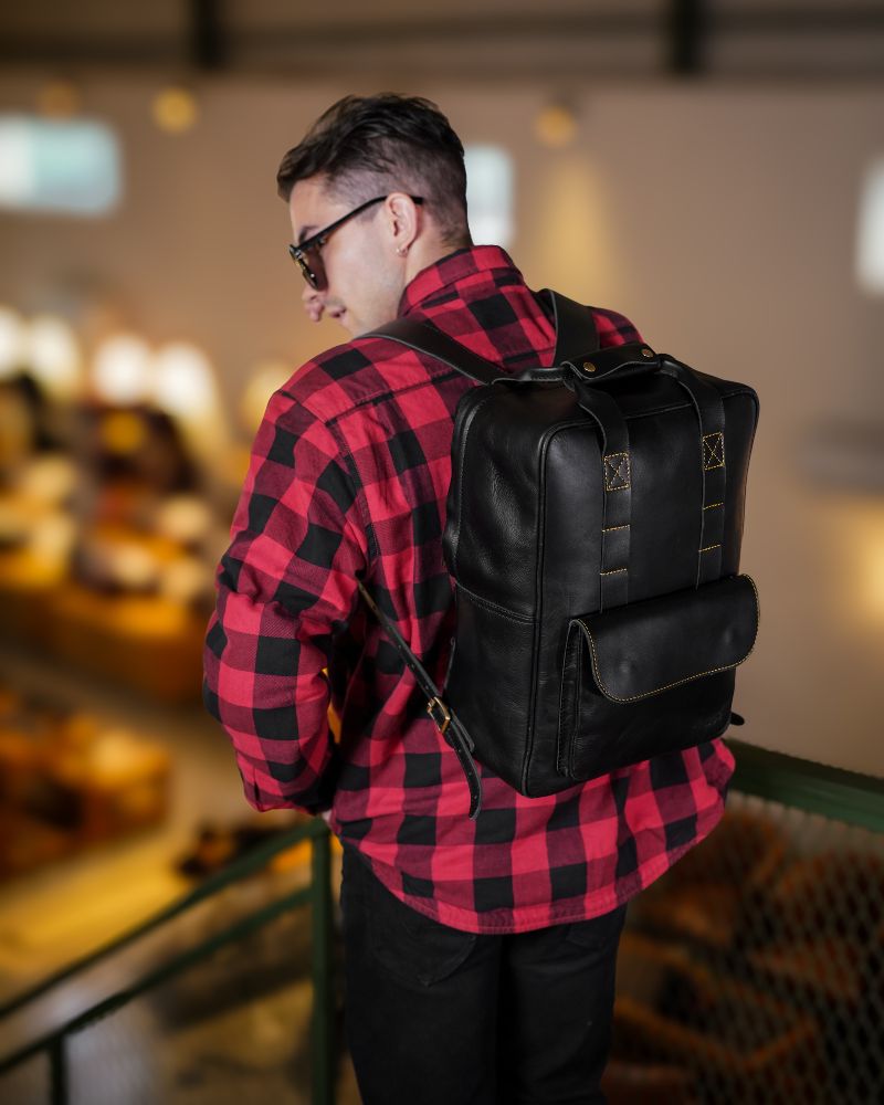 Handmade genuine leather black color eastwood backpack carried by a man on his back