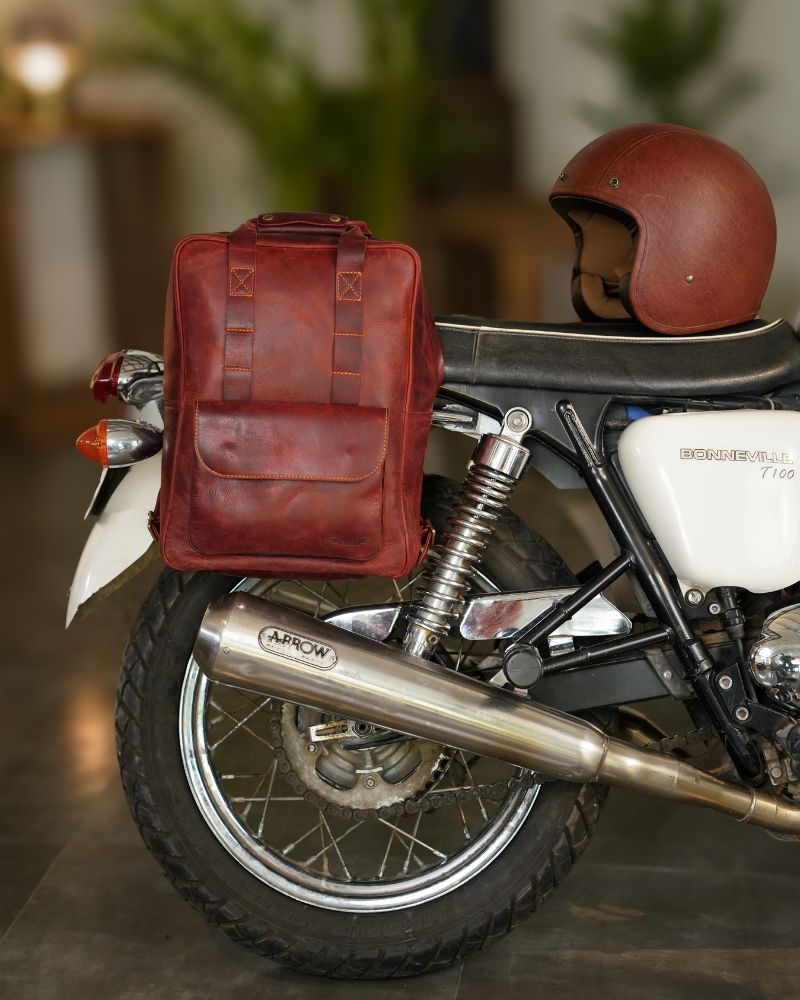 Front view of handmade genuine leather cherry red color eastwood backpack mounted on a motorcycle