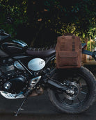 Handmade genuine leather brown color eastwood backpack mounted as saddlebag on a parked bike