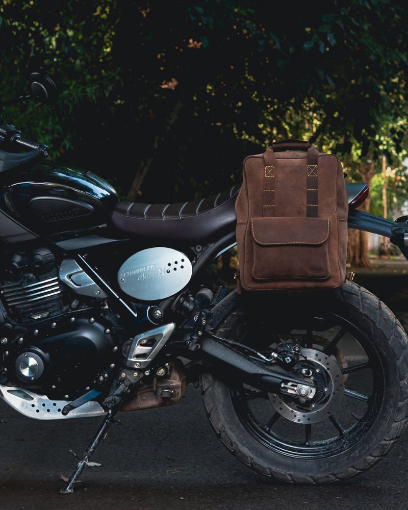 Handmade genuine leather brown color eastwood backpack mounted as saddlebag on a parked bike