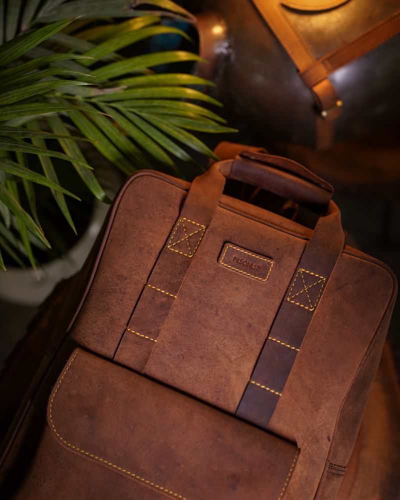 Front view of handmade genuine leather brown color eastwood backpack on wooden log