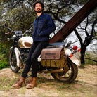 This image features a stylish and rugged expedition saddlebag designed specifically for the Triumph Bonneville series, including the Super Meteor 650, Shotgun 650, and Meteor 350 models. The saddlebag, crafted from 16 oz heavy-duty canvas and complemented by a leather finish, showcases a sturdy and durable design.