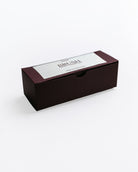 Black rectangular box with a white label on a white background