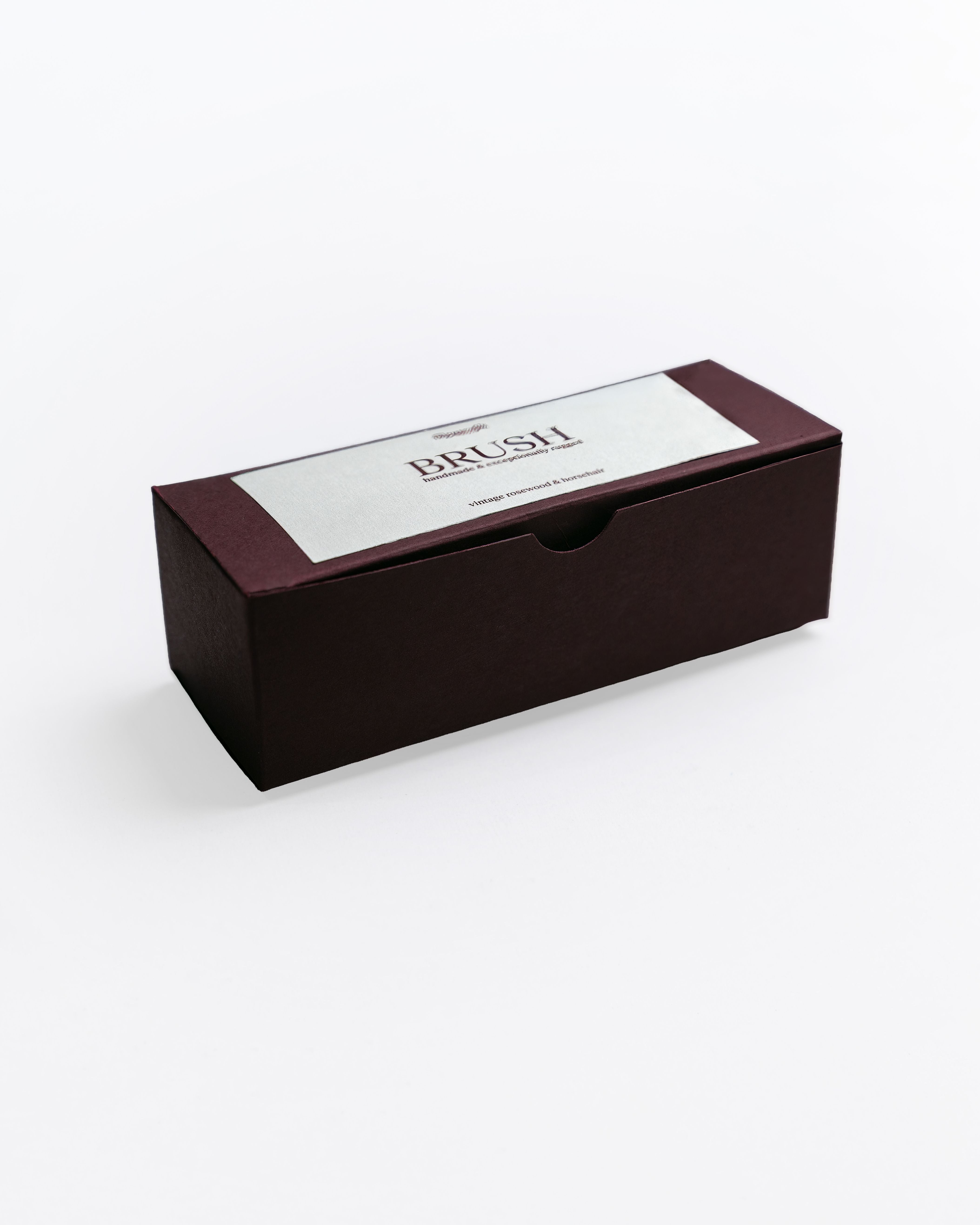 Black rectangular box with a white label on a white background