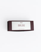 Box of brushes with a white label on a light gray background