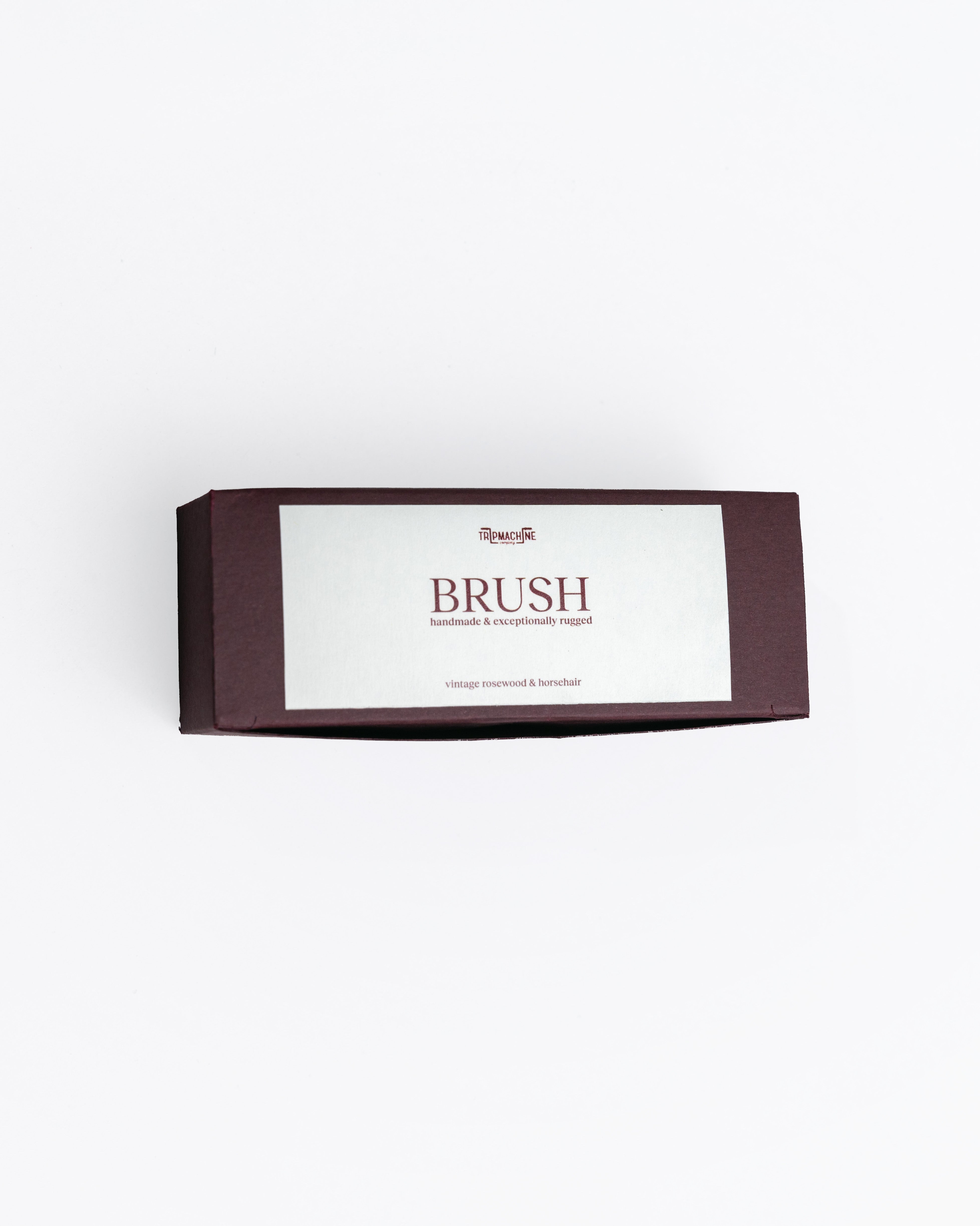 Box of brushes with a white label on a light gray background