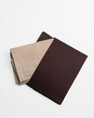 Two cleaning cloth in brown envelope, on a white background