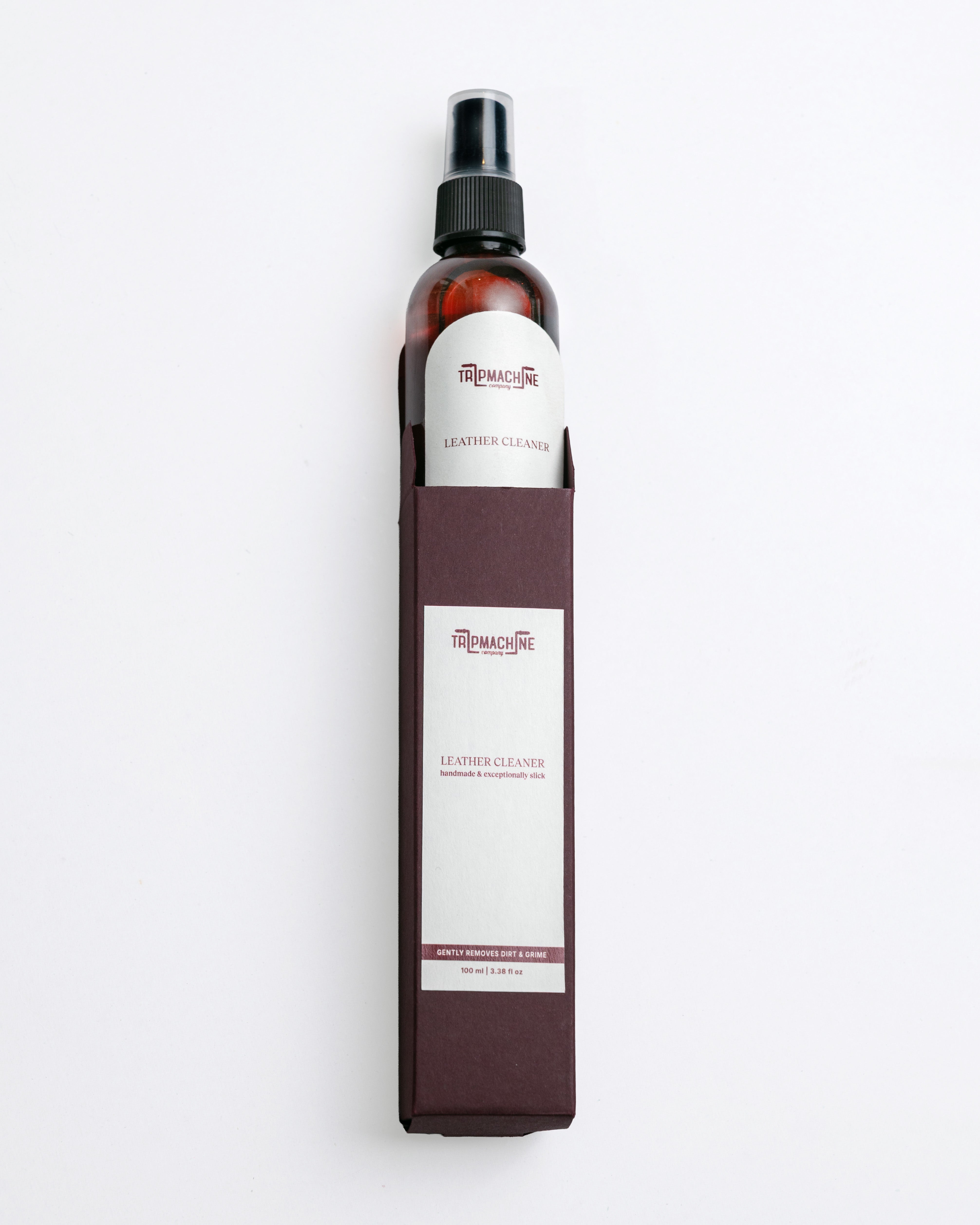 Leather cleaner spray bottle with a white label on a white background