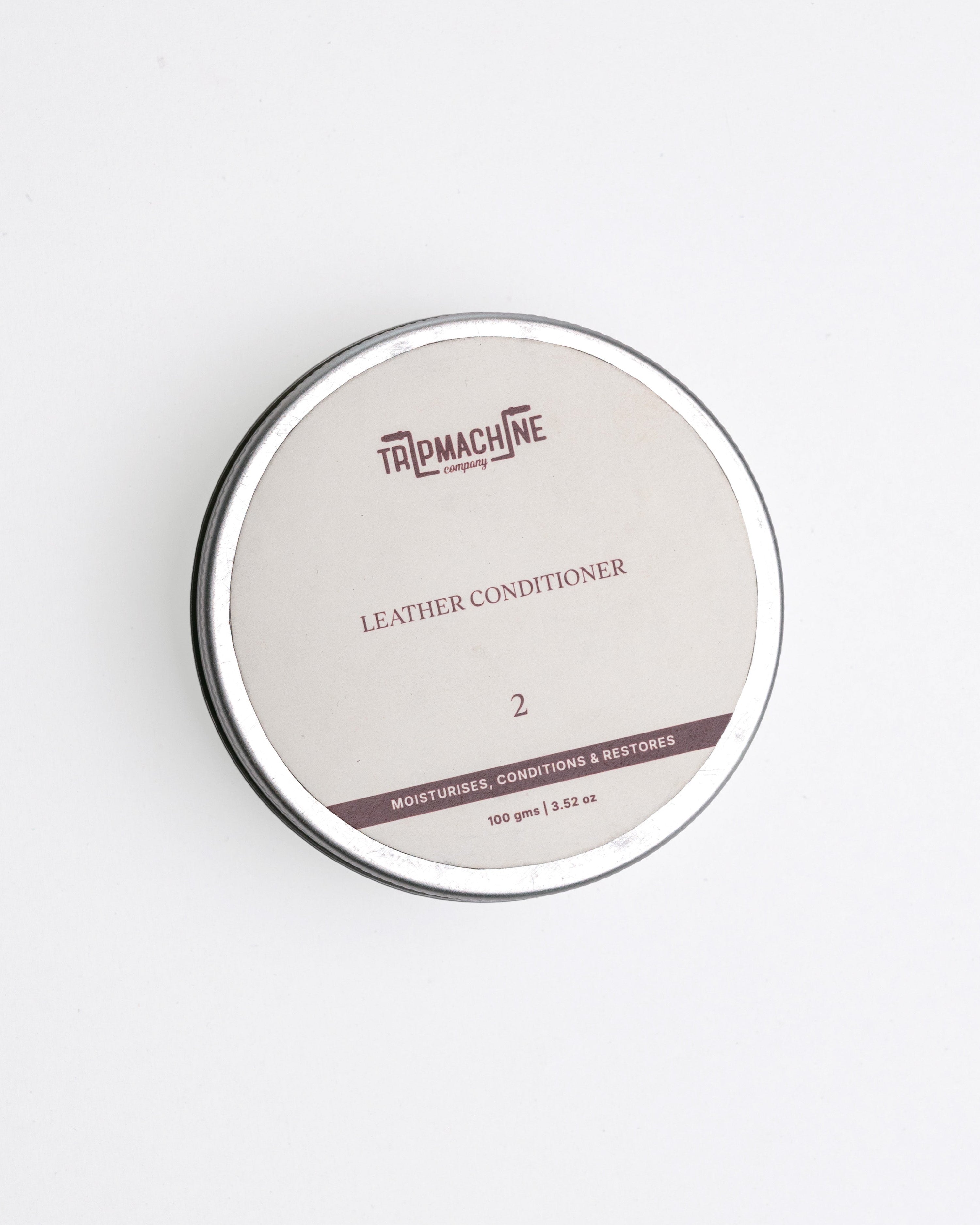 Leather conditioner container with 'TripMachine' branding on a white background