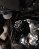 Close-up of a motorcycle handlebar with a Union Jack design on the throttle grip.