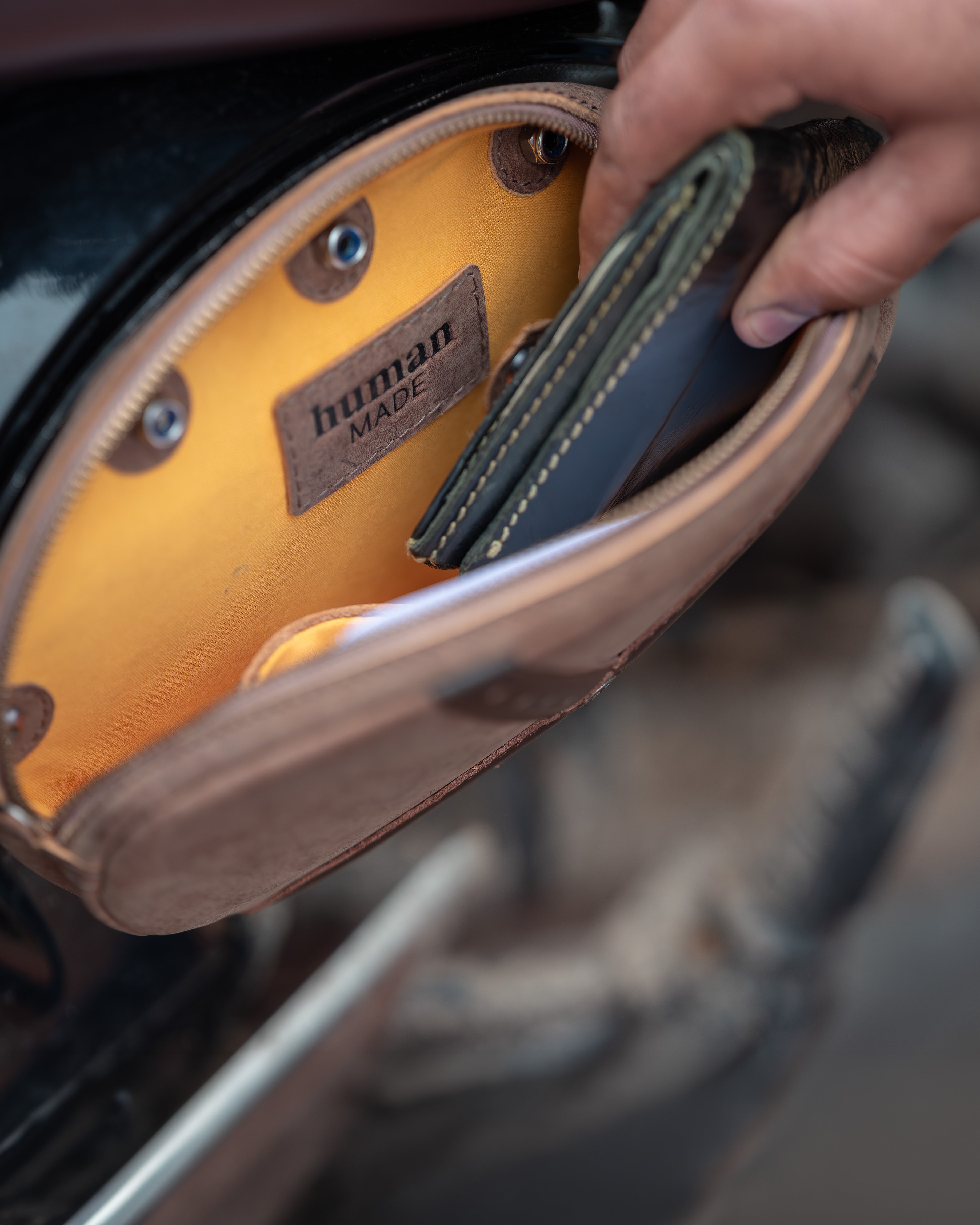 Close-up of a leather product with 'human made' label inside a car.