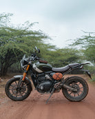 Motorcycle on a dirt road with trees in the background