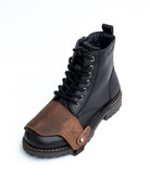 Black and brown leather boot with a white background
