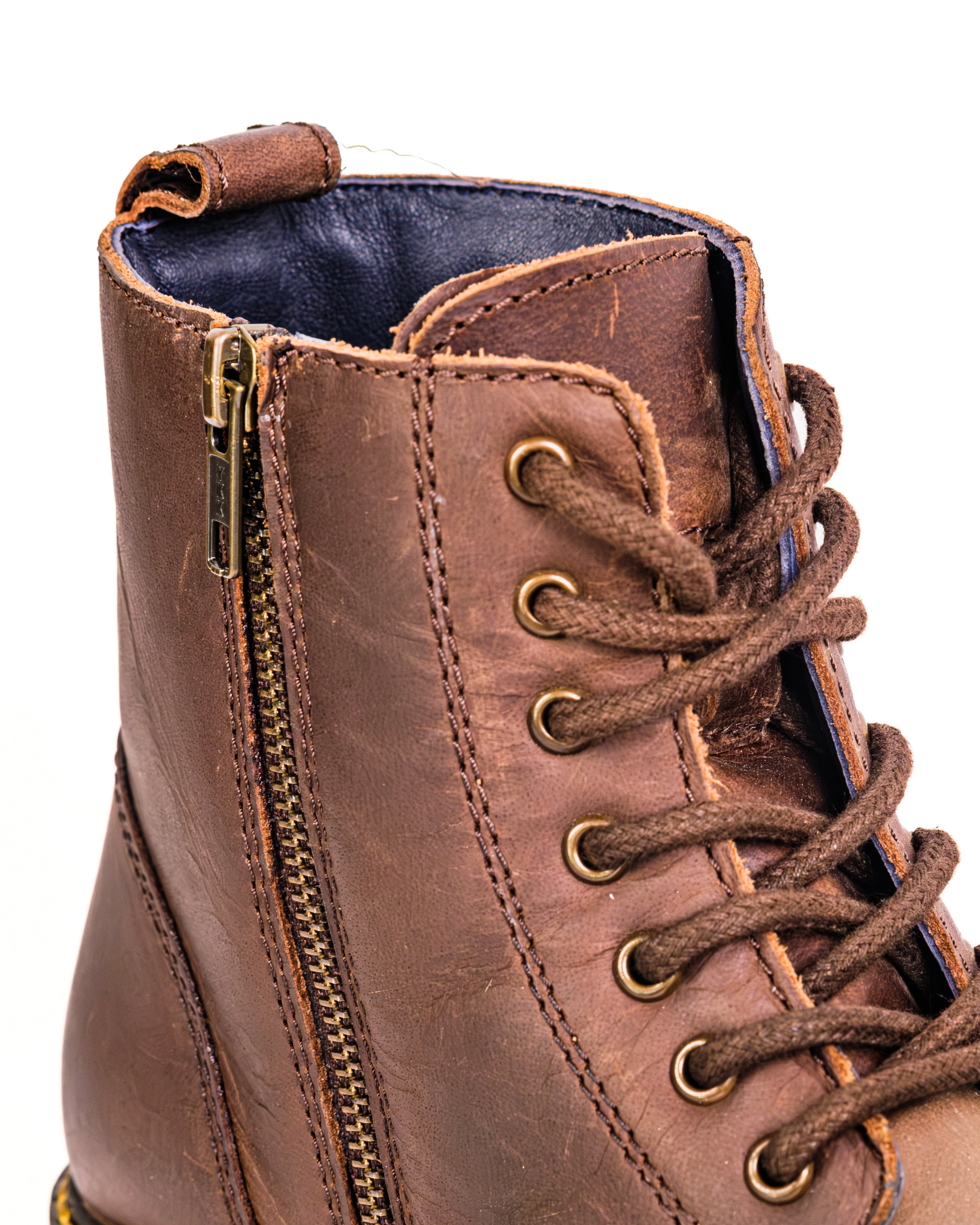Brown leather boot with laces and a zipper on a white background